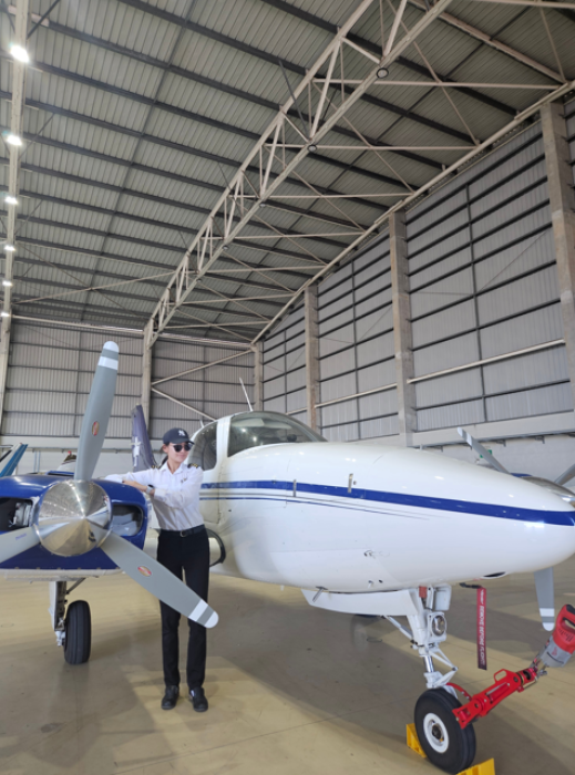 Ah Young Kim next to small plane