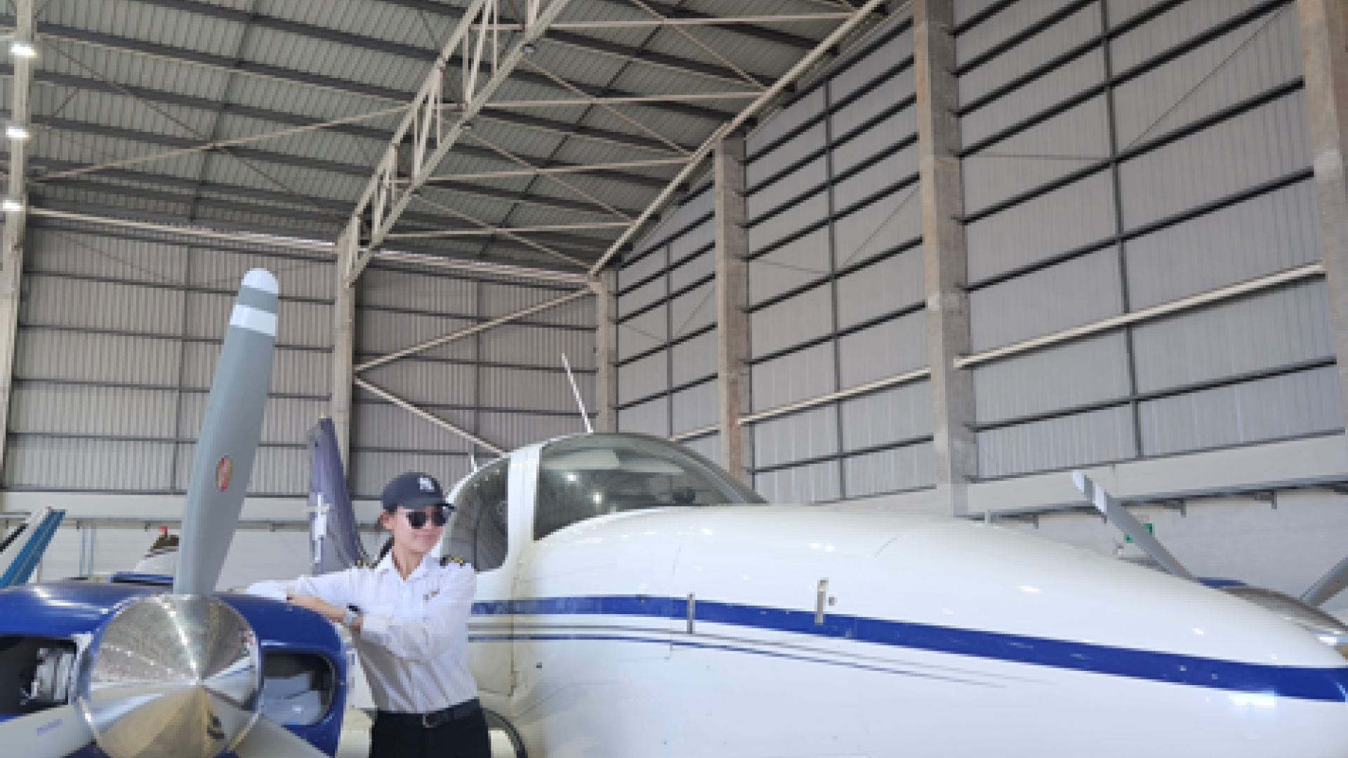 Ah Young Kim next to small plane