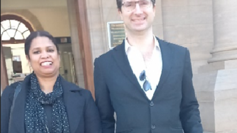 Two lawyers standing next to each other outside court