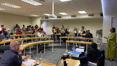 group gathered in seminar environment in discussion