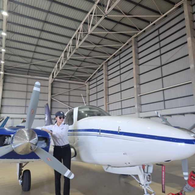 Ah Young Kim next to small plane