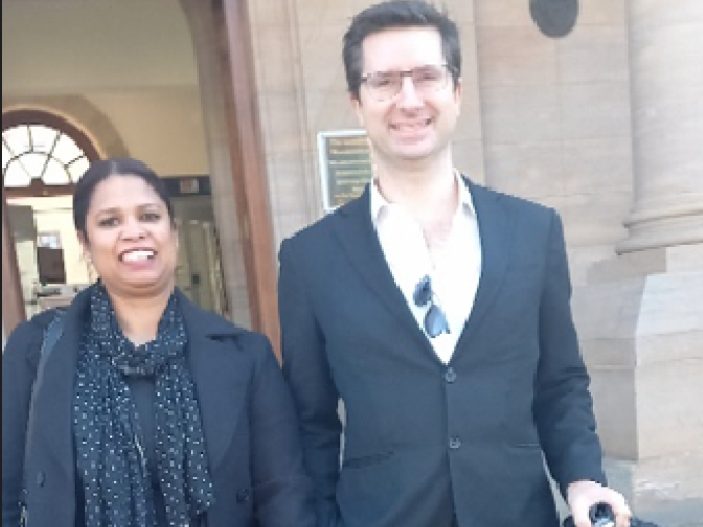 Two lawyers standing next to each other outside court