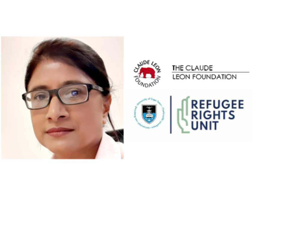 academic faces camera, hair swept back, with specs, and two logos