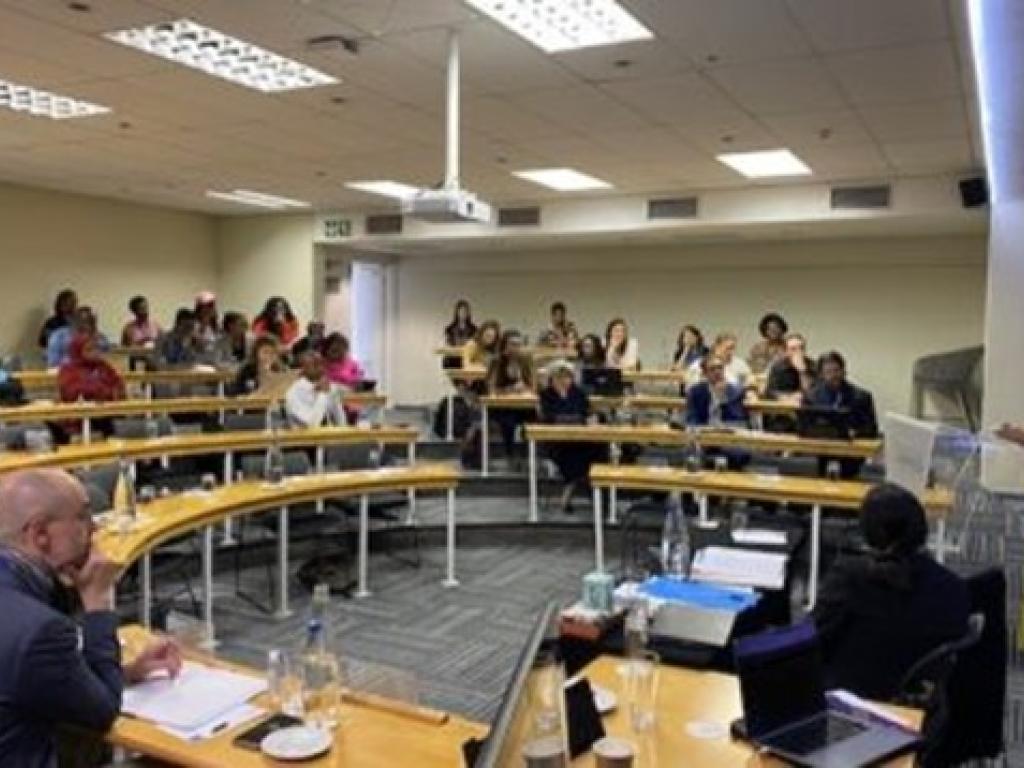 group gathered in seminar environment in discussion